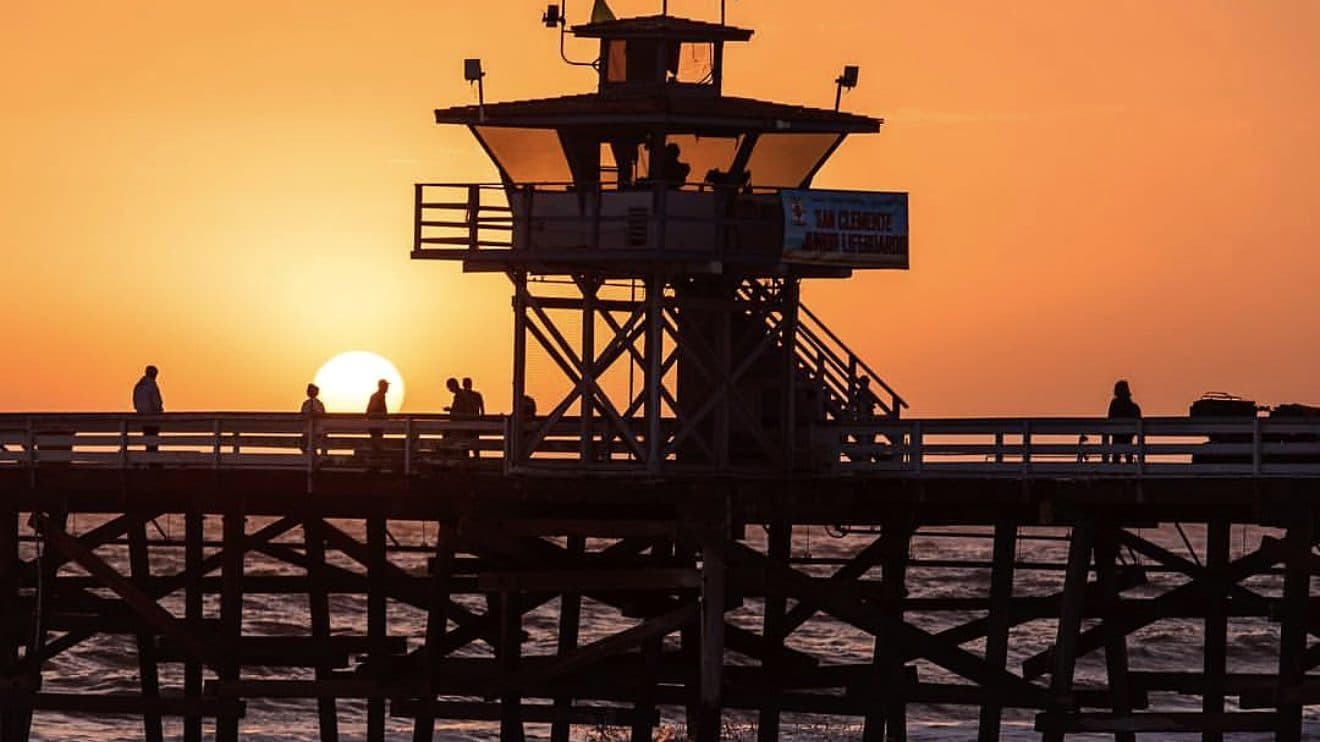 San Clemente Pier lifeguard tower silhouetted at sunset